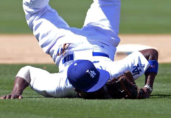 Dodgers second baseman Dee Gordon lands on his face after making a play and throwing out Arizona's Tony Campana at first base during the Dodgers' 6-3 loss.