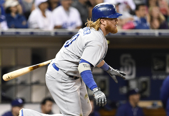 Dodgers third baseman Justin Turner hits a single during the third inning of the team's 3-2 loss in 12 innings to the San Diego Padres.