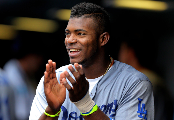 Dodgers right fielder Yasiel Puig cheers in the dugout after a teammate scores a run during the team's 8-2 win over the Colorado Rockies.