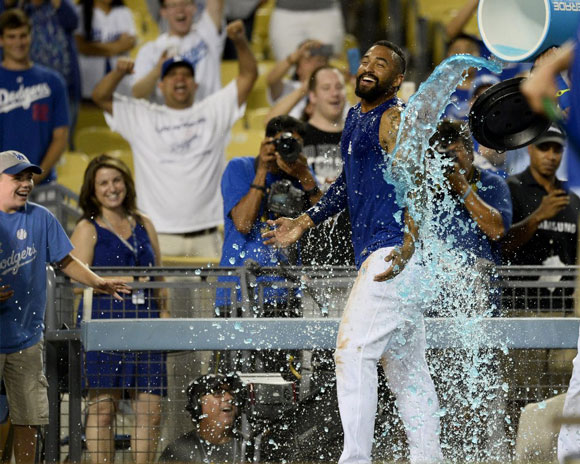 Matt Kemp is doused with a sports drink after knocking in the winning run.
