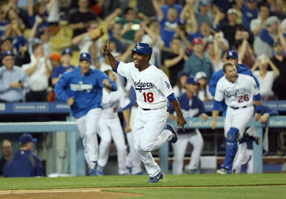 Chone Figgins races home with the winning run in the 10th inning.