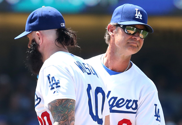 Dodgers Manager Don Mattingly, right, pulls reliever Brian Wilson from the game during the eighth inning of the team's 5-4 loss to the Cleveland Indians.