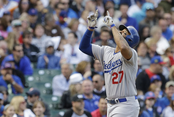 Matt Kemp points to the sky after hitting a two-run homer against the Cubs.