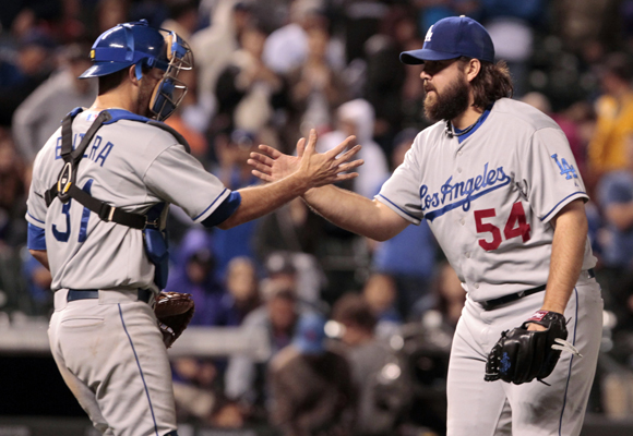 Dodgers catcher Drew Butera, left, congratulates reliever Chris Perez at the end of the team's 7-2 win over the Rockies.