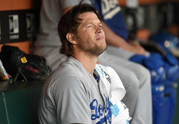 Dodgers starter Clayton Kershaw looks on from the dugout during the fifth inning of the team's 5-0 win over the San Francisco Giants.