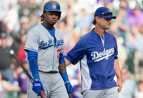 Dodgers Manager Don Mattingly, right, consoles Hanley Ramirez after he strikes out in the ninth inning of the team's 5-4 loss in 10 innings to the Colorado Rockies.