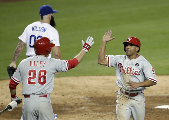Ben Revere, right, is greeted by Chase Utley after he scored on a double hit by Carlos Ruiz. Dodgers reliever Brian Wilson is in the background. 