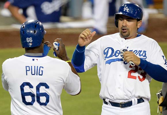 Dodgers teammates Yasiel Puig, left, and Adrian Gonzalez celebrate after scoring on a Matt Kemp (not pictured) double in the seventh inning.