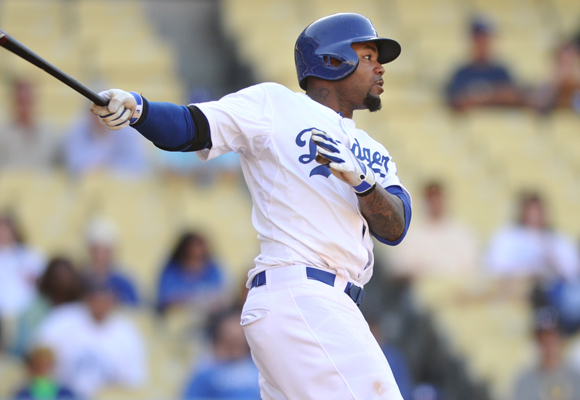 Dodgers outfielder Carl Crawford hits a two-run home run in the 12th inning of an 8-5 loss in 14 innings to the Washington Nationals.
