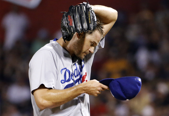 Dodgers reliever Jamey Wright wipes his head during the sixth inning of the team's 12-7 loss to the Pittsburgh Pirates.
