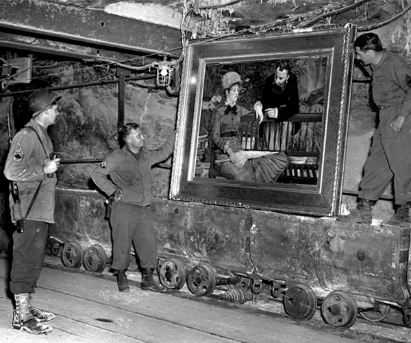 American soldiers looking at Edouard Manet's "In the Wintergarden," a painting German Nazis had stored in a Thuringian mine. 