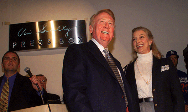 Vin Scully is all smiles at the dedication ceremony at Dodger Stadium. His wife, Sandy, is on his right.