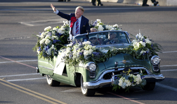 Scully waves to spectators at the 125th Rose Parade in Pasadena, Calif.