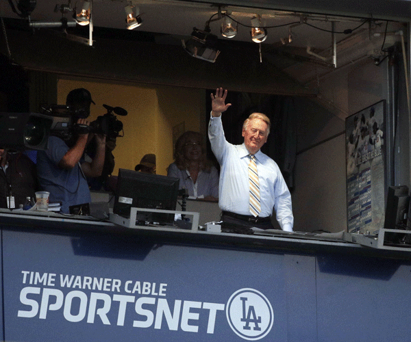 Scully acknowledges the crowd at Dodger Stadium after the team announced that Scully would return for his 66th season. 
