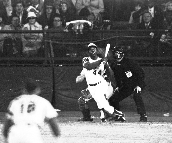 Hank Aaron watches his 715th home run sail out of the park. The hit comes against Dodgers reliever Al Downing.