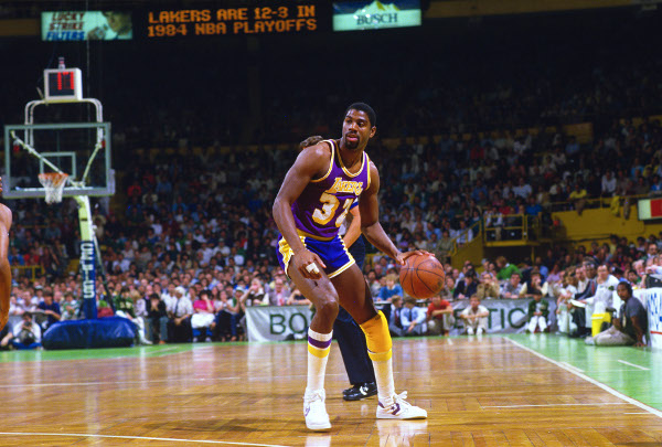 Los Angeles Lakers' Earvin Magic Johnson dribbles the ball up court against the Boston Celtics during the 1984 NBA Basketball Finals at the Boston Garden in Boston.