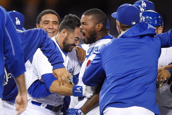 Dodgers second baseman Howie Kendrick celebrates with his teammates after hitting a walk-off, two-run single in the ninth inning to seal the victory over the Mariners.