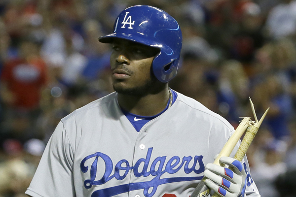 Dodgers right fielder Yasiel Puig walks back to the dugout after striking out and breaking his bat in a loss to the Texas Rangers.