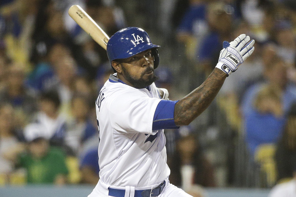 Dodgers second baseman Howie Kendrick hits a run-scoring double during the fifth inning against the Rockies.