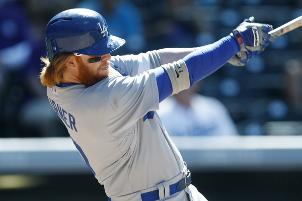 Dodgers third baseman Justin Turner hits a single during the ninth inning of the Dodgers' loss to the Colorado Rockies in the first game of a doubleheader.