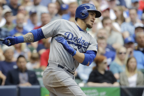 Dodgers catcher Yasmani Grandal hits a two-run single during the sixth inning of a win over the Milwaukee Brewers.