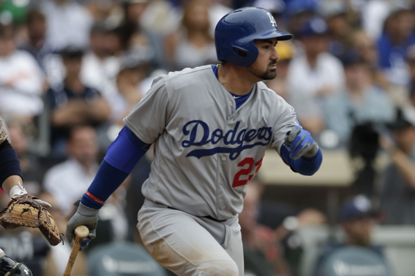 Dodgers first baseman Adrian Gonzalez hits a two-run single during the 12th inning of a win over the San Diego Padres.