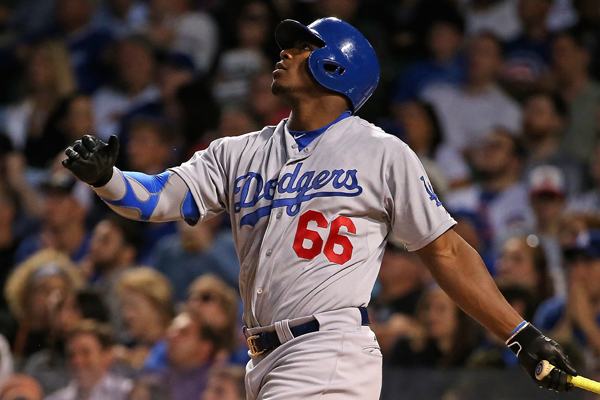 Dodgers right fielder Yasiel Puig hits a triple during the sixth inning of a 1-0 loss to the Chicago Cubs.
