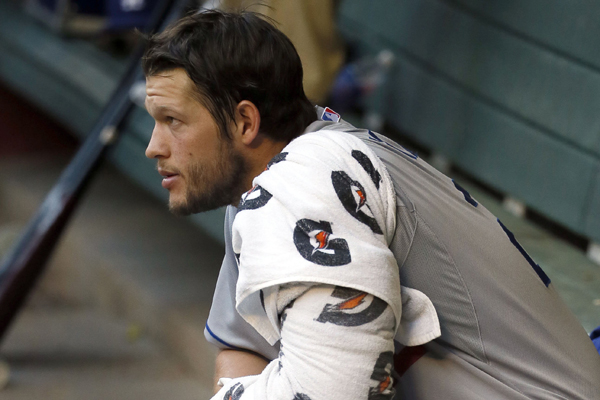 Dodgers pitcher Clayton Kershaw sits in the dugout during the fourth inning of a 6-0 loss to the Arizona Diamondbacks.