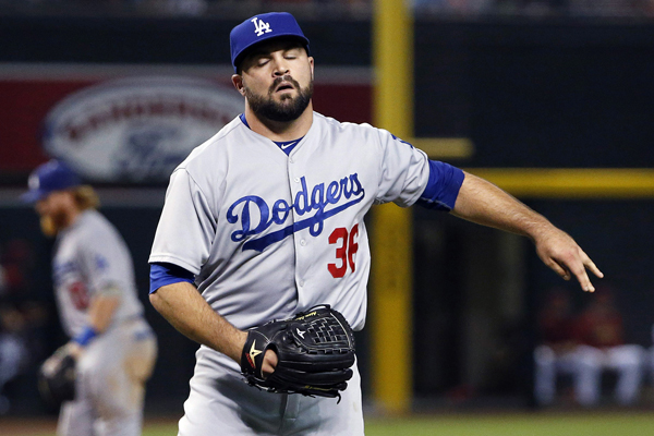 Dodgers reliever Adam Liberatore reacts after giving up a triple during the seventh inning of a 10-6 loss to the Arizona Diamondbacks.