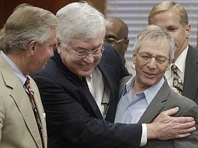 Lawyers Dick DeGuerin, left, and Mike Ramsey, center, congratulate Robert Durst after hearing that jurors in found him not guilty of murdering his neighbor Morris Black.