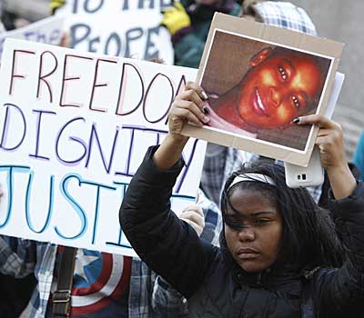 A protester holds a poster of Tamir Rice during a rally in Cleveland, Ohio.