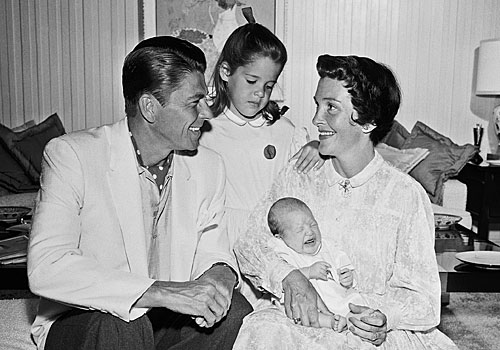 Ronald Reagan and Nancy pose with their month-old son, Ron Reagan, and their daughter Patti, 5 1/2, shown in June 1958 file photo.
