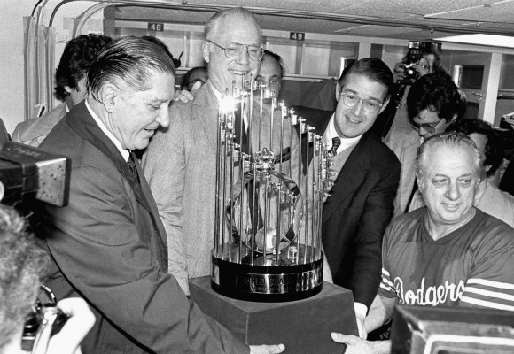 Los Angeles Dodgers Vice President Al Campanis, left, Baseball Commissioner Bowie Kuhn, Dodgers President Peter OMalley and Manager Tommy Lasorda, right, pose with the World Series Championship trophy in 1981.