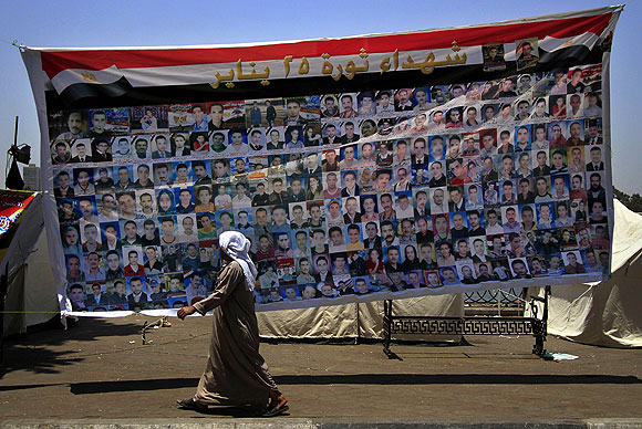 A banner in Cairo labeled "Martyrs of the Jan. 25 Revolution" features pictures of protesters slain by Egyptian security forces during the uprising.