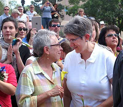 Gail Stockman, left, and Beth Black of Albuquerque, N.M., are shown with other couples preparing to marry at a massive wedding in Albuquerque Civic Plaza on Aug. 27, 2013. 