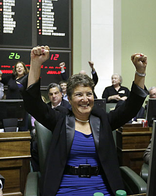 Rhode Island state Sen. Donna Nesselbush reacts seconds after the state Senate passed a same-sex marriage bill. Nesselbush was the main sponsor of the bill.