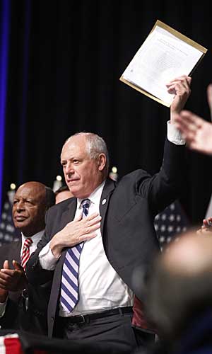 llinois Gov. Pat Quinn holds up the Religious Freedom and Marriage Fairness Act.