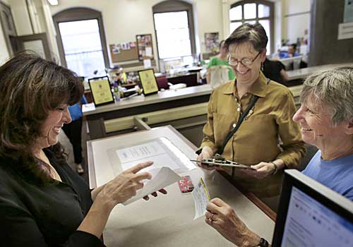 Lisa Kesser, right, and her partner of 20 years Dorcey Baker, both of Providence, R.I., obtain a marriage license from chief clerk Gina DiRuzzo-Beeley, left, at City Hall, in Providence. 