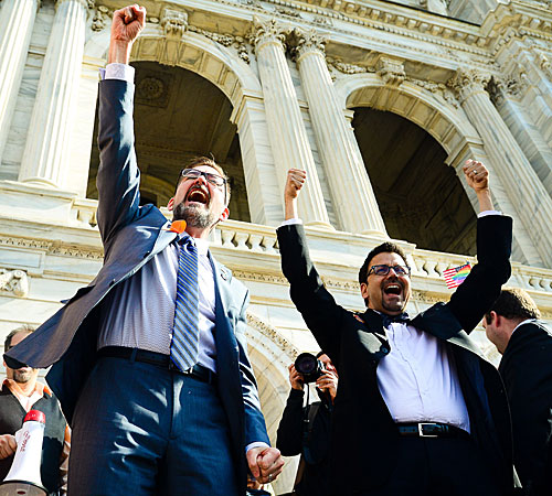 State Sen. Scott Dibble, left, sponsor of a bill to legalize same-sex marriage in Minnesota, greets a crowd with his partner, Richard Leyva, at the Capitol.