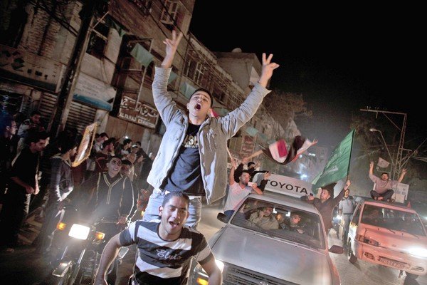 Palestinians in Gaza City celebrate the cease-fire agreement between Israel and Hamas.