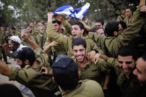 Israeli soldiers dance to music provided by visitors who turned up to show their support at the border with the Gaza Strip.