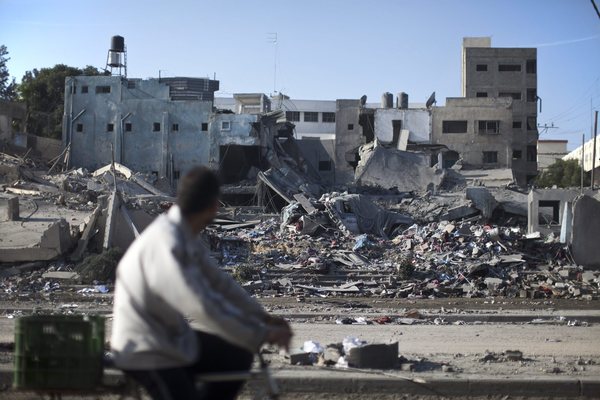 A Palestinian man surveys the ruins of a Hamas police station destroyed by an Israeli airstrike in Gaza City on Tuesday. The weeklong clash has diverted attention from other Middle East conflicts and put existing alliances under pressure.