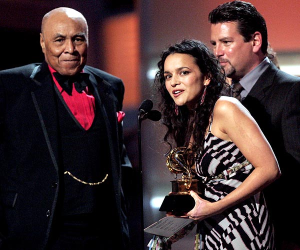 Singer Norah Jones and the late Ray Charles' manager, Joe Adams, accept the award for album of the year on his behalf at the 47th Grammy Awards.