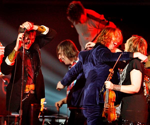 Members of Arcade Fire celebrate after winning album of the year at the 53rd Grammy Awards.