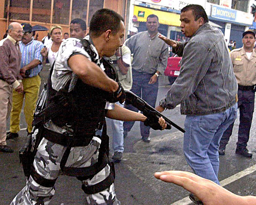 Venezuelan police try to control demonstrators in Caracas on April 10, during the second day of a national strike.