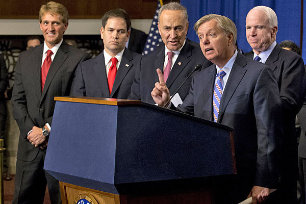 Sen. Lindsey Graham, second from right, speaks about immigration reform during a news conference in Washington.