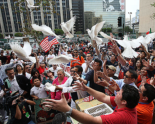 State Sen. Gil Cedillo (D-Los Angeles) helps release doves at the beginning of one of several marches in downtown Los Angeles.